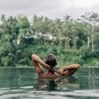 Swimming in infinity pool with a jungle view in Ubud.