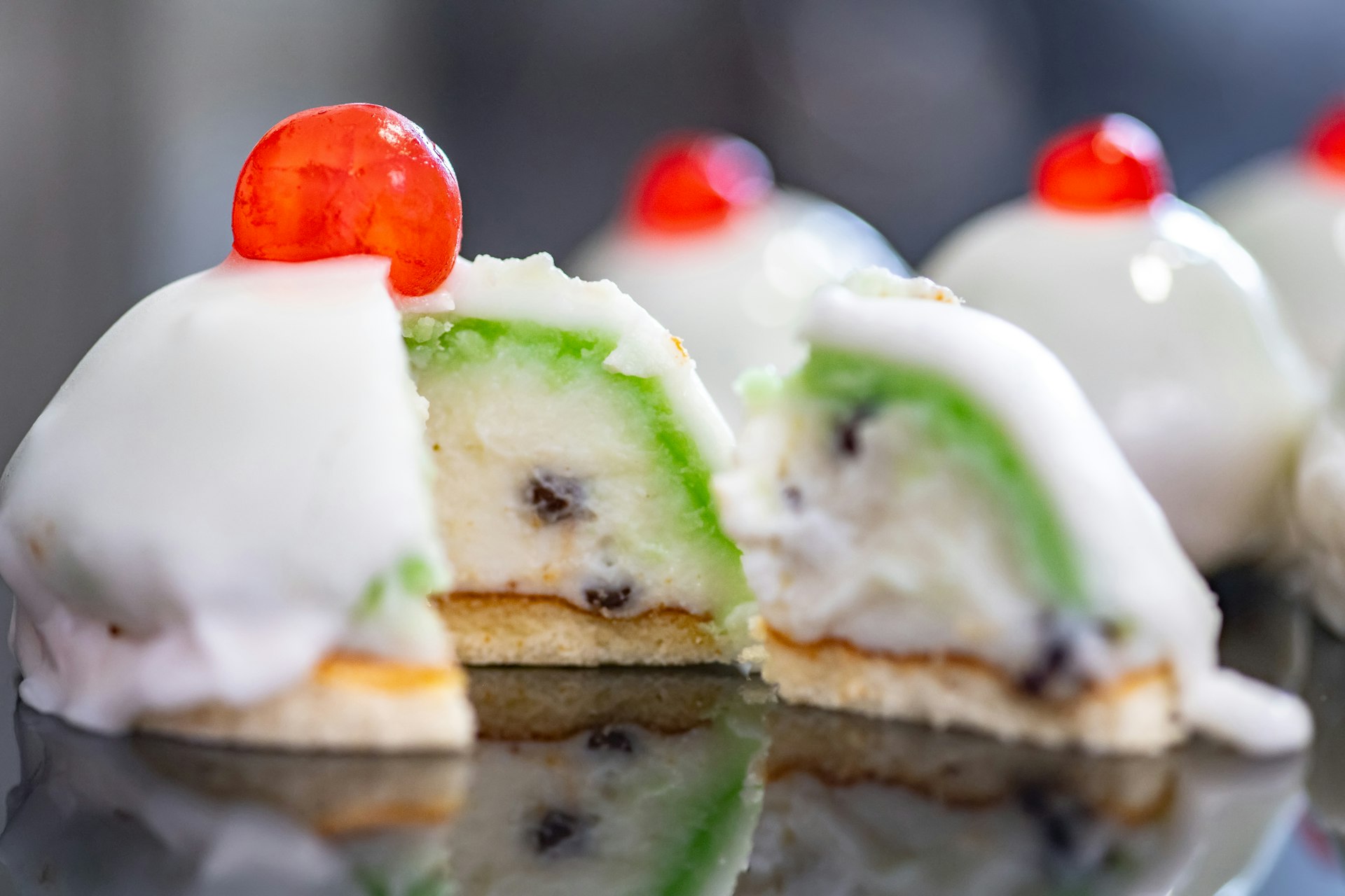 Cross-section of a Sicilian cassata, a sweet dessert cake made with ricotta, vanilla, pea-green icing and candied fruit
