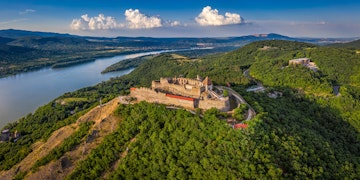 Visegrad, Hungary - Aerial panoramic drone view of the beautiful high castle of Visegrad with summer foliage and trees. Dunakanyar and blue sky with clouds at background; Shutterstock ID 2054526830; your: Barbara Di Castro; gl: 65050; netsuite: digital; full: hub
2054526830