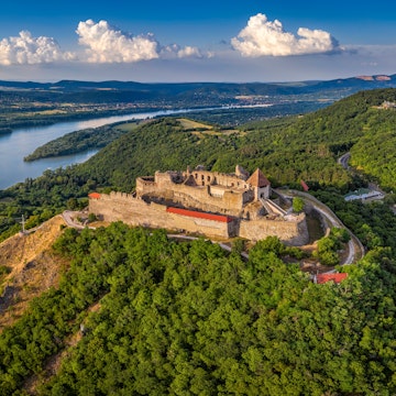 Visegrad, Hungary - Aerial panoramic drone view of the beautiful high castle of Visegrad with summer foliage and trees. Dunakanyar and blue sky with clouds at background; Shutterstock ID 2054526830; your: Barbara Di Castro; gl: 65050; netsuite: digital; full: hub
2054526830