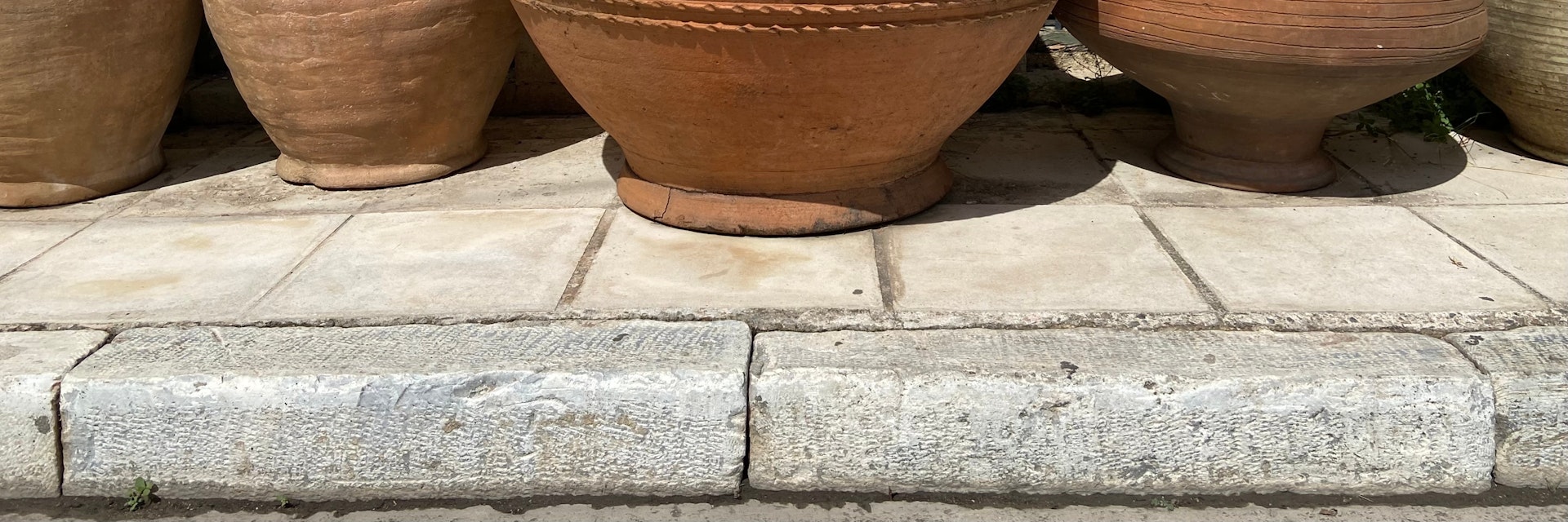 A row of pottery in different shapes and sizes lined up outside against the wall of a museum in the Keramikos neighborhood of Athens, Greece; Shutterstock ID 2222064069; your: Erin Lenczycki; gl: 65050; netsuite: Digital; full: POI
2222064069
