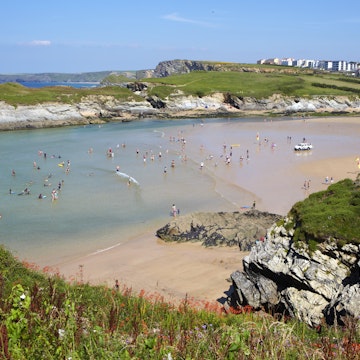 Tourists, swimmers and holidaymakers at Lusty Glaze Beach along the Cornish Coastline