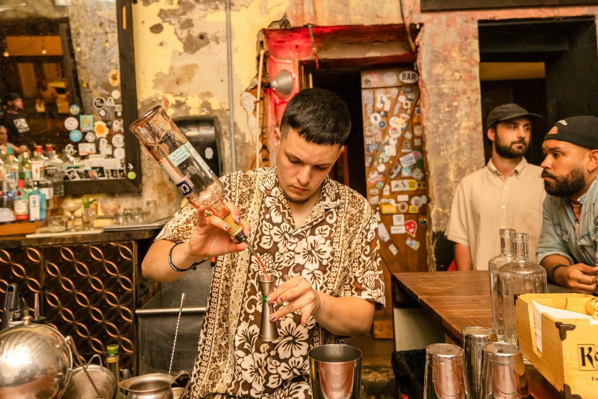 A member for bar staff mixes up a cocktail in a bar