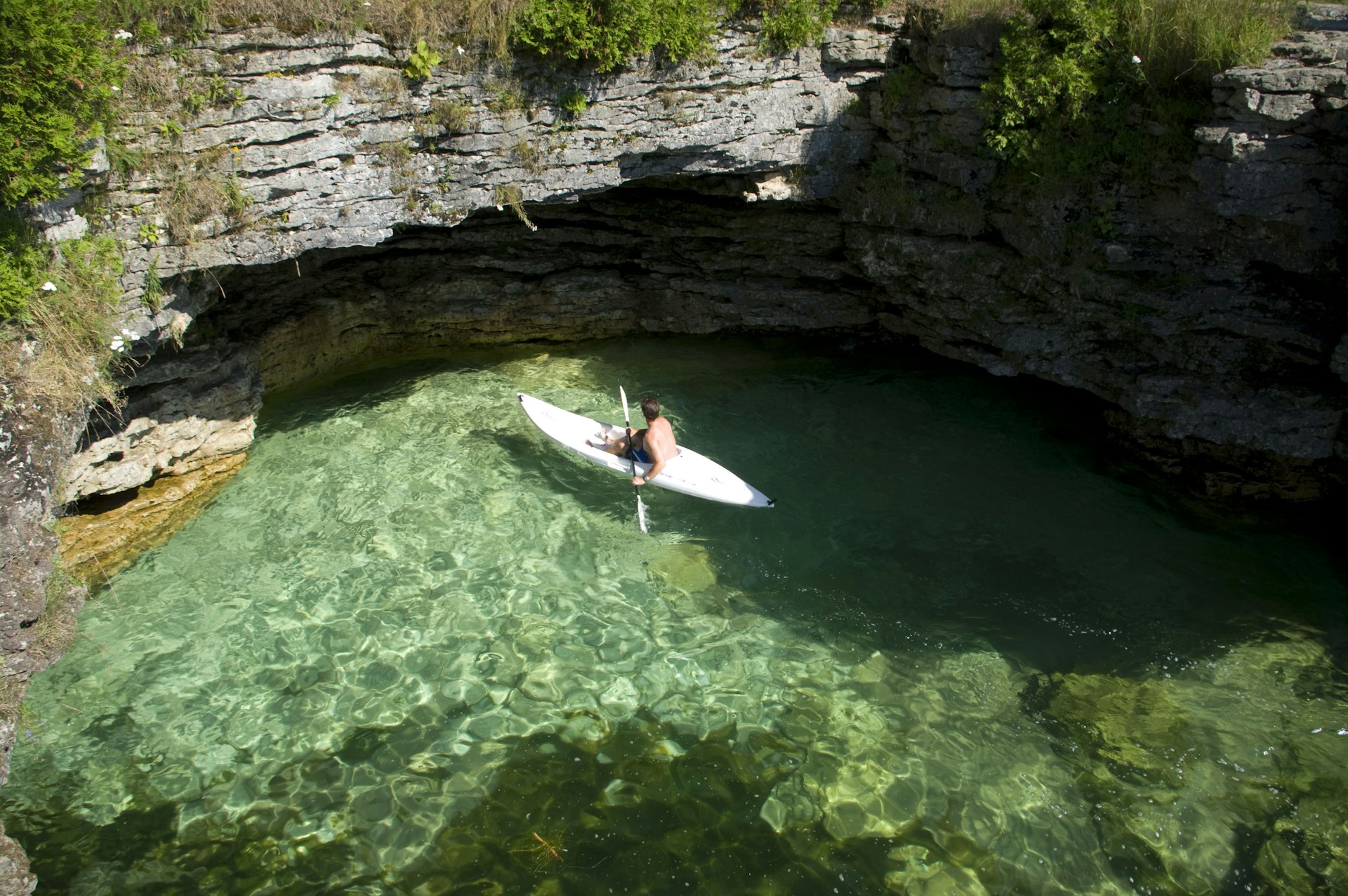 A man kayaks in Cave Point County Park, Lake Michigan, Door County, Wisconsin, Midwest, USA