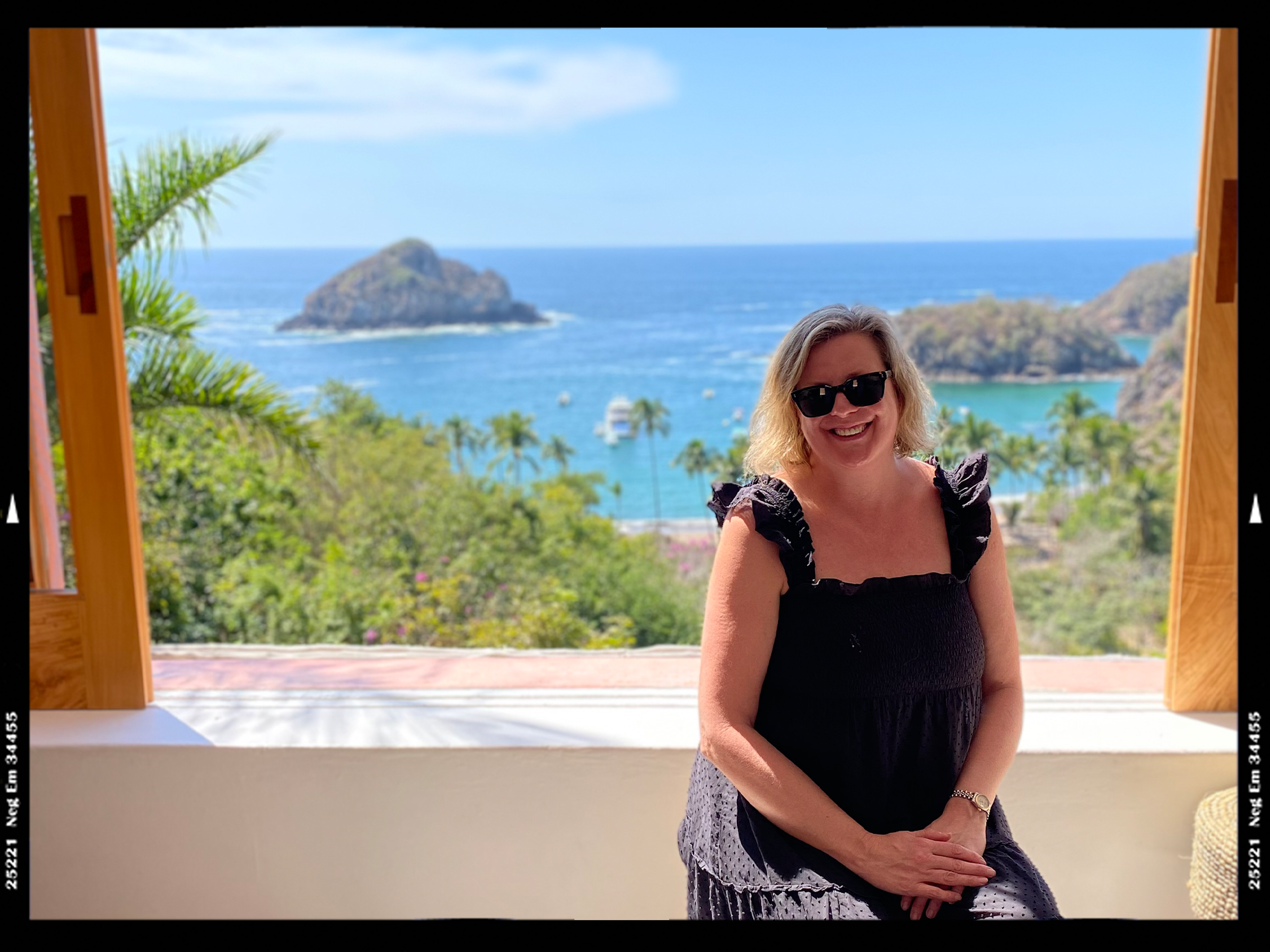 Author Brekke poses by a sunlit window