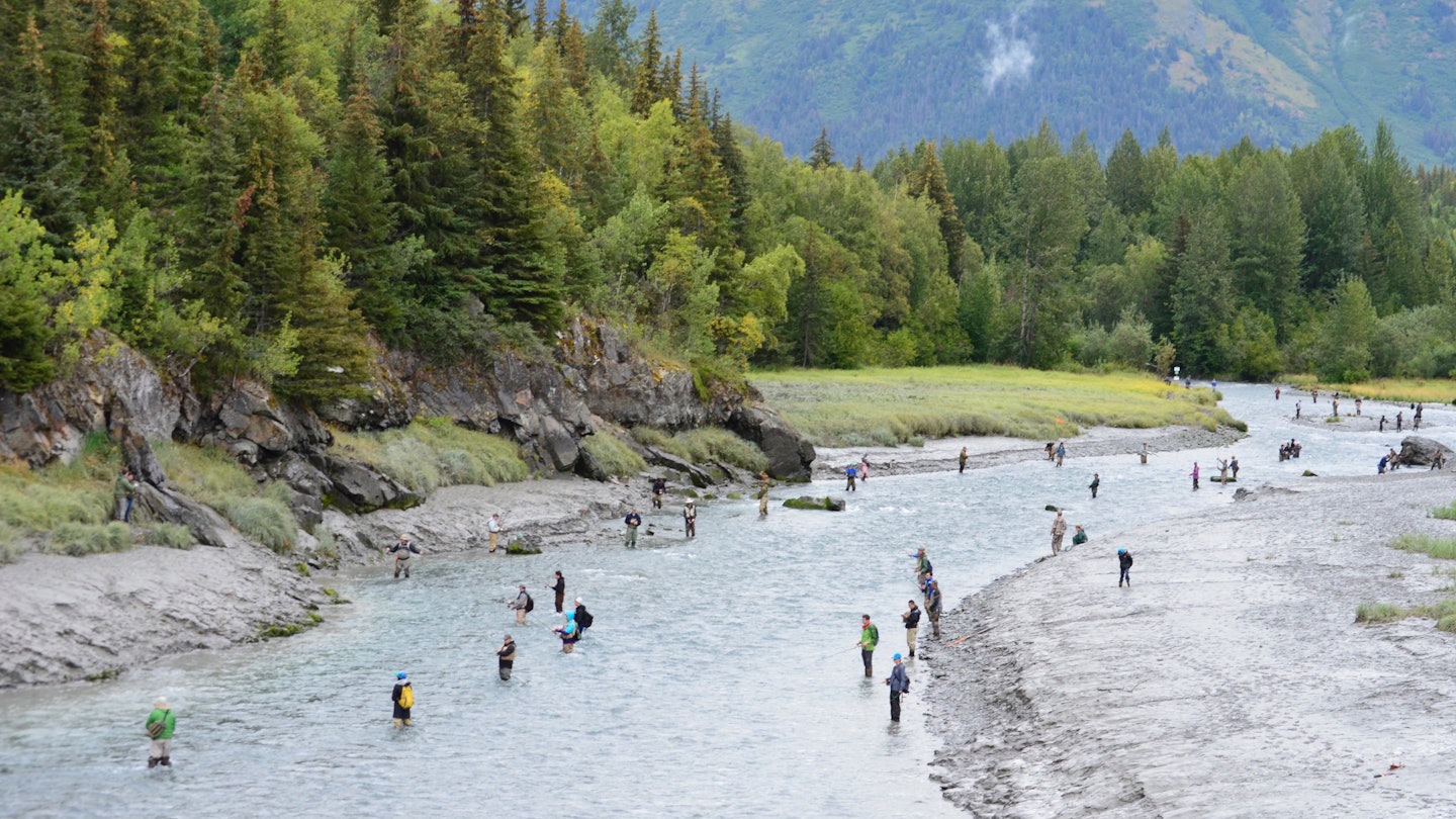 Bird Creek is lined with fisherman hoping to catch silver salmon against the backdrop of the Chugach Mountains on the outskirts of Anchorage, AK.