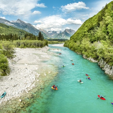 People kayaking on the river Soča in Slovenia.
