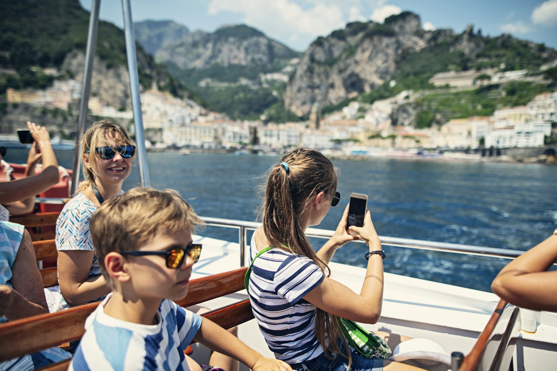 Passengers enjoying a ferry boat ride near the famous city of Amalfi, Campania, Italy