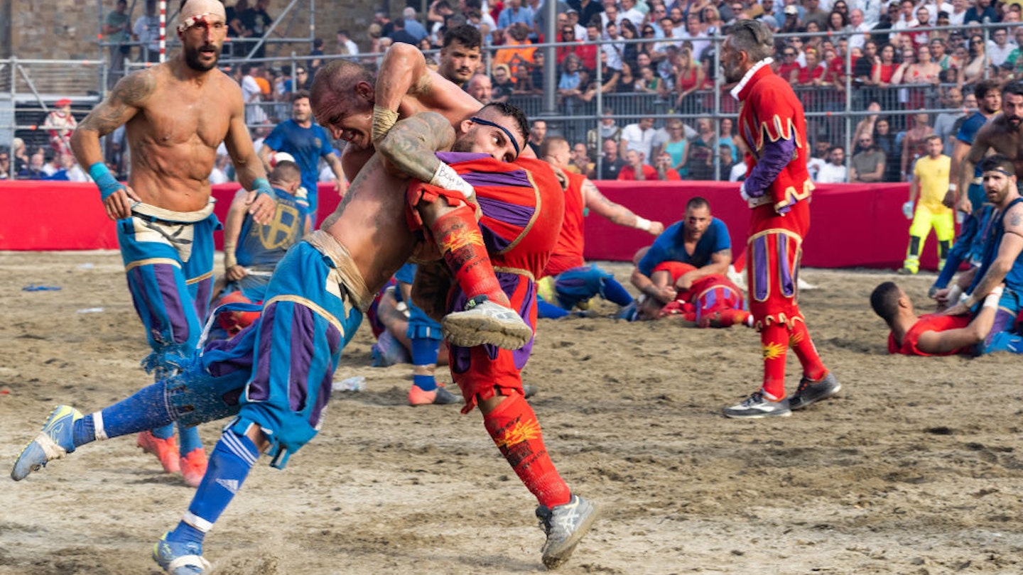 FLORENCE, ITALY - JUNE 24: Two opposing teams from two of the four historical neighborhoods in Florence, wrestle during the Calcio Storico on June 24, 2022 in Florence, Italy. Calcio Storico originated in the 16th century, and is a mix between soccer, wrestling, and rugby. (Photo by Megan Varner/Getty Images)
1242054088
calcio
Two teams battle it out in a game of calcio storico in Florence