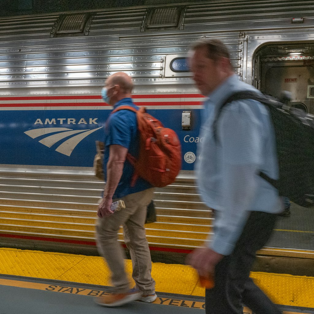 People walk to an Amtrak train in the Moynihan Train Hall on September 15, 2022 in New York City.