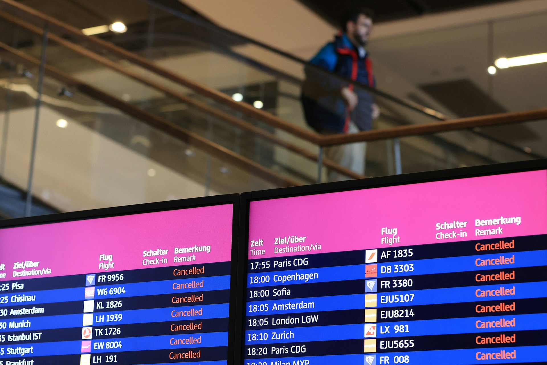 Flight information boards display cancelled flights, during a strike by ground services employees