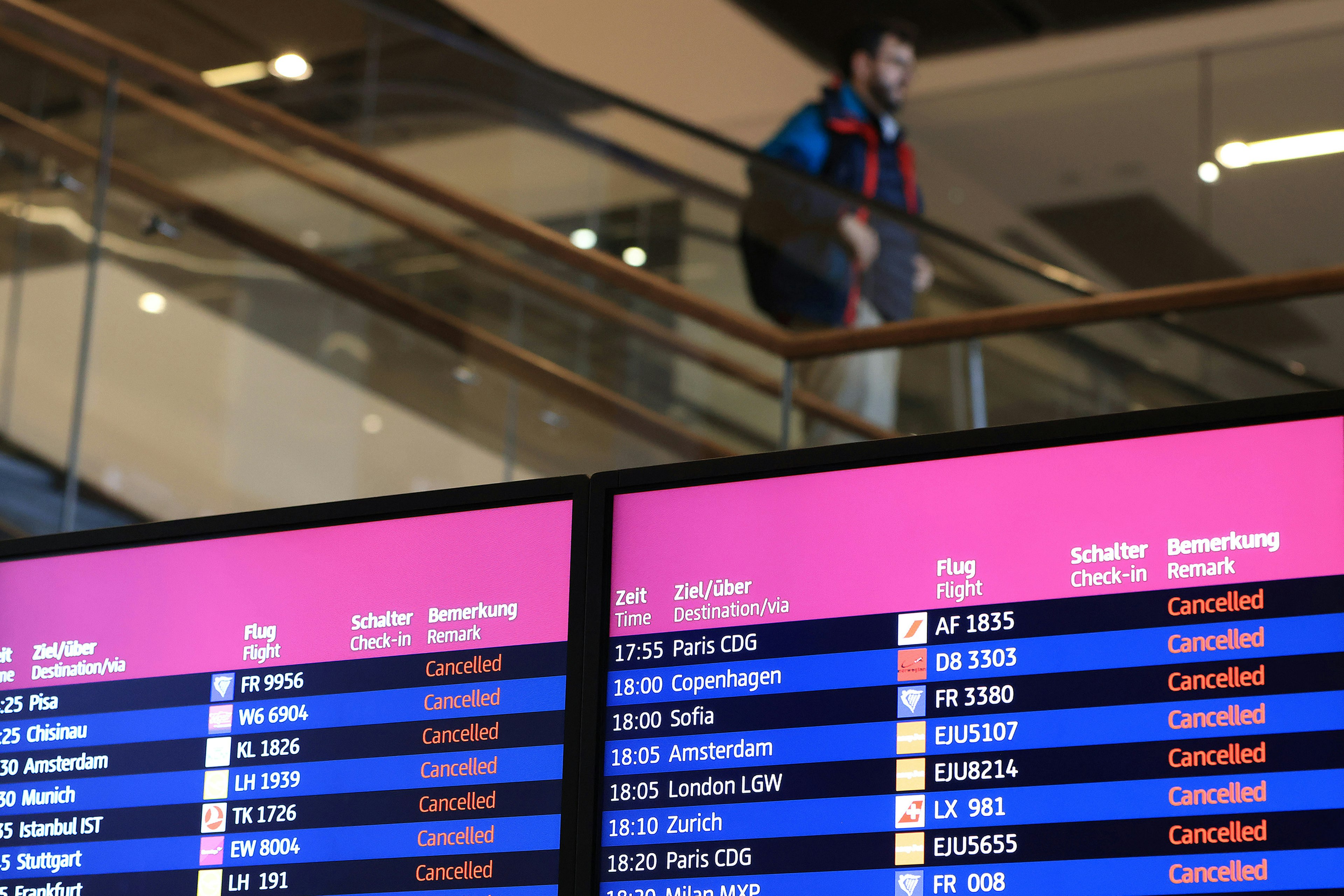 Flight information boards display cancelled flights, during a strike by ground services employees