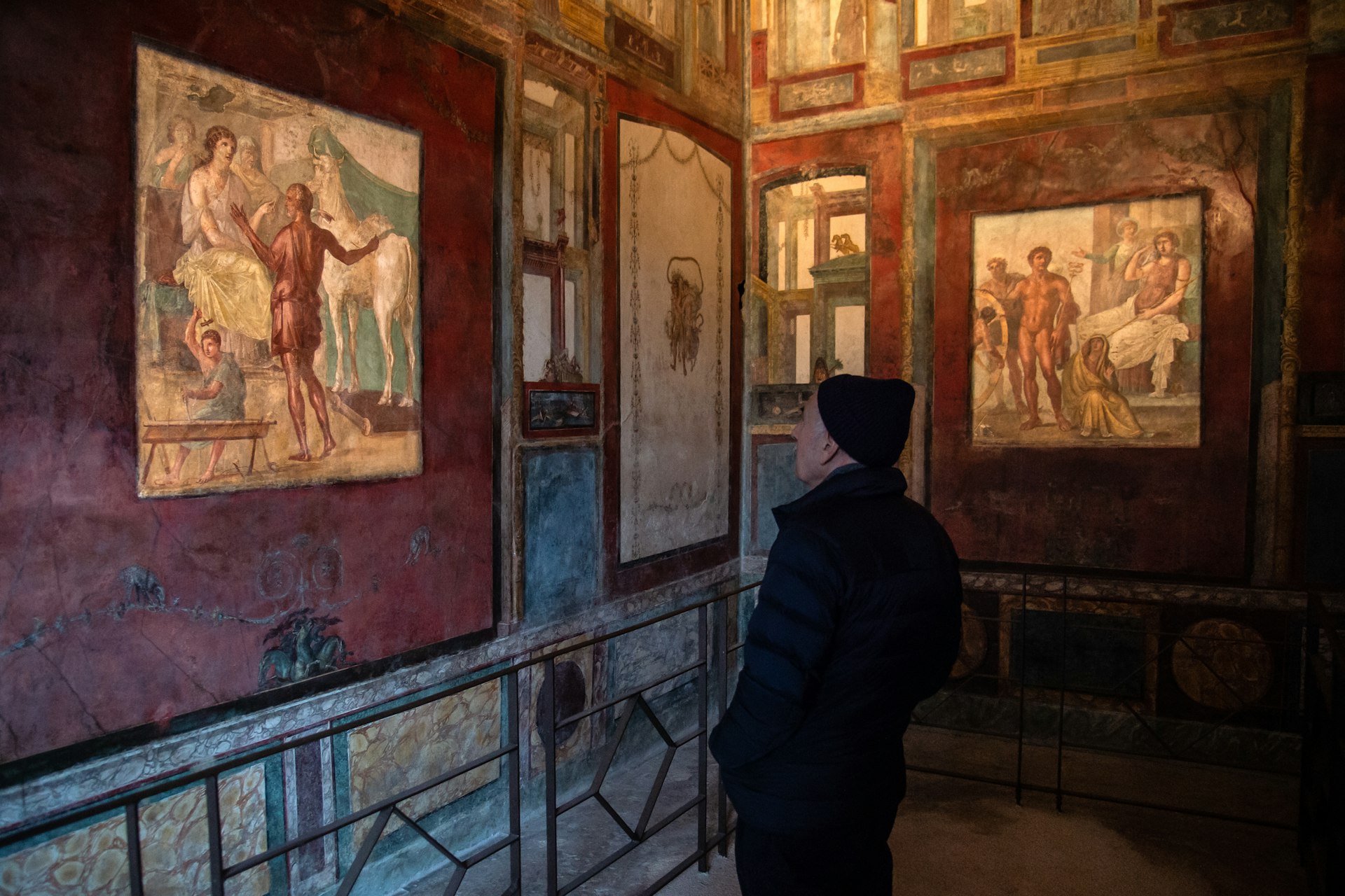 A man looks at newly restored frescos in the Casa dei Vettii, Archaeological Park of Pompeii, Catania, Italy