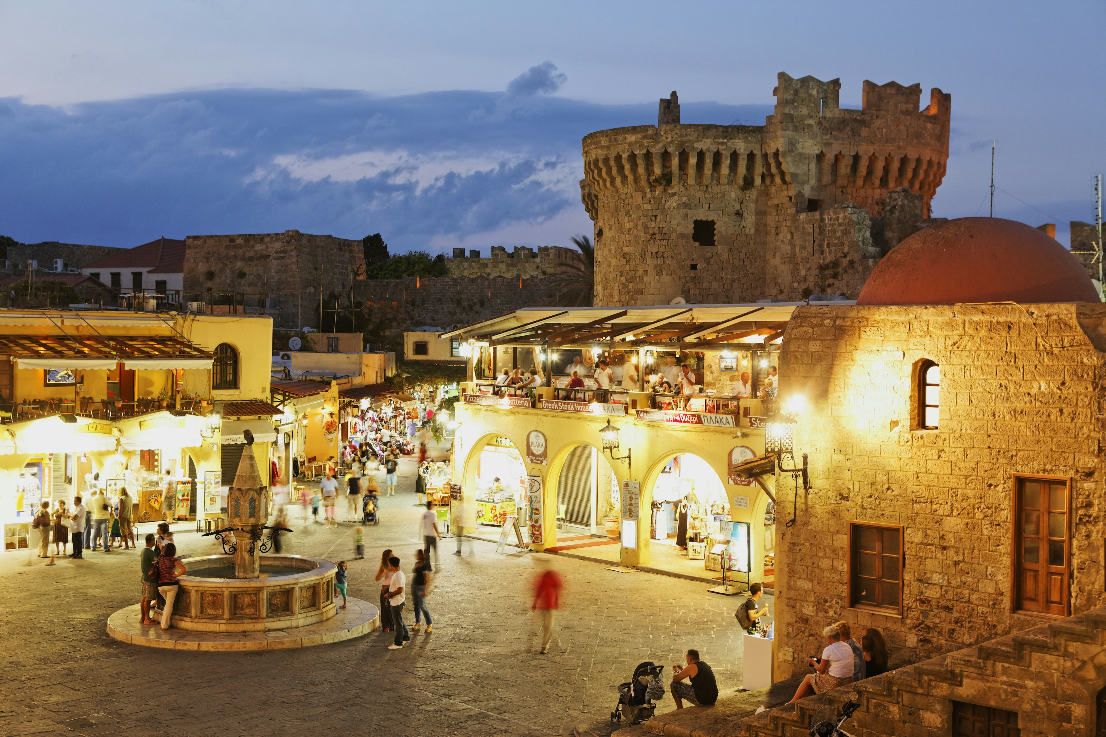 Tourists at night in the historic town center of Rhodes, Dodecanese, Greece