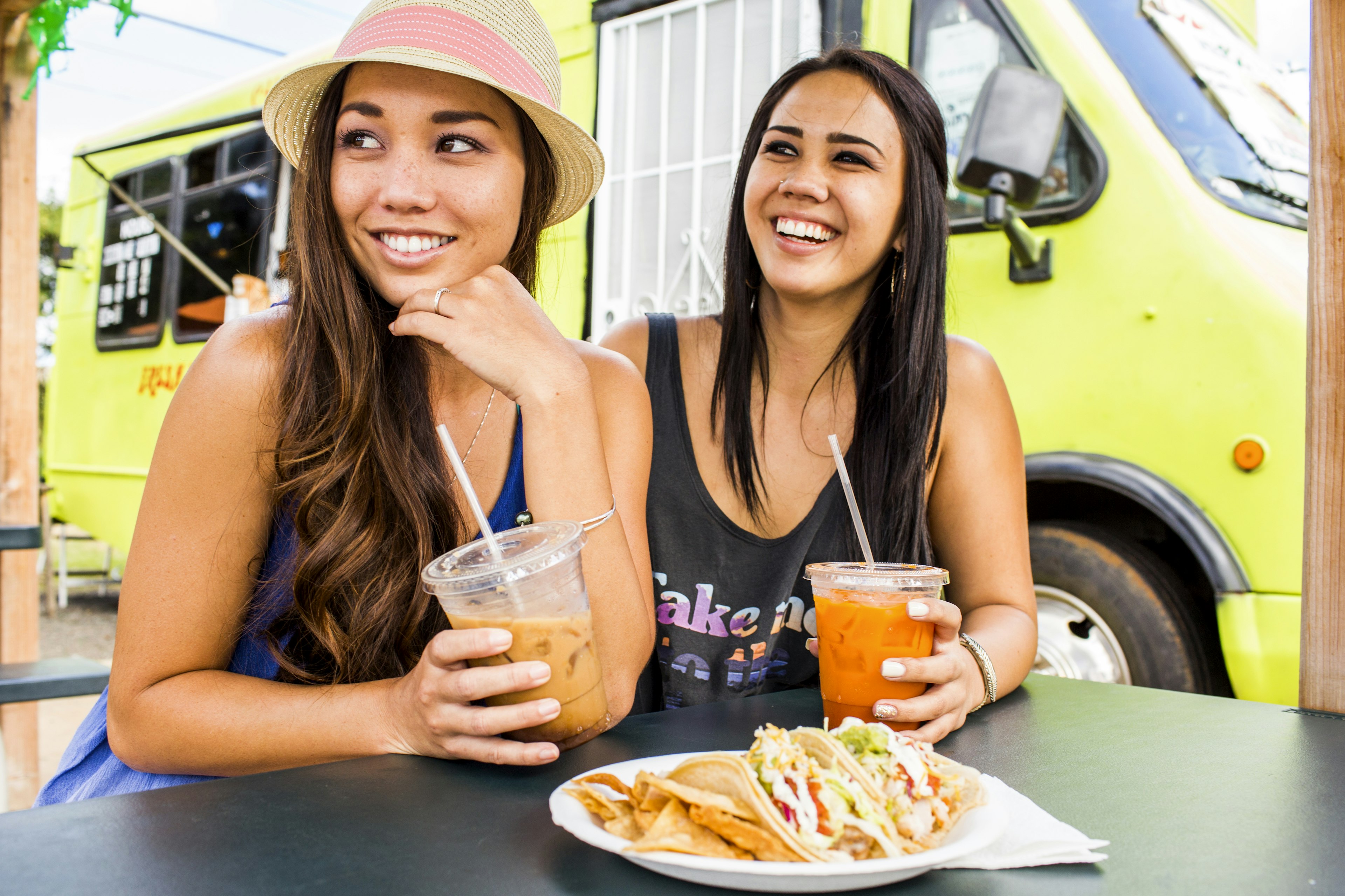 546821185
20-24 years, adventure, bonding, brunette, cart, color image, convenience, day, disposable cup, drinking, eating, enjoying, food and drink, food truck, friend, front view, girlfriend, happy, hat, Hawaii, head and shoulders, holding, horizontal, hungry, journey, laughing, leisure activity, lifestyle, long hair, looking away, outdoors, pacific islander ethnicity, people, photography, plastic cup, plate, Poipu, road trip, sitting, smiling, straw, summer, taco, take out food, tank-top, together, toothy smile, transportation, travel, truck, two people, United States, woman, young adult, young women
Pacific Islander women eating and drinking near food cart - stock photo