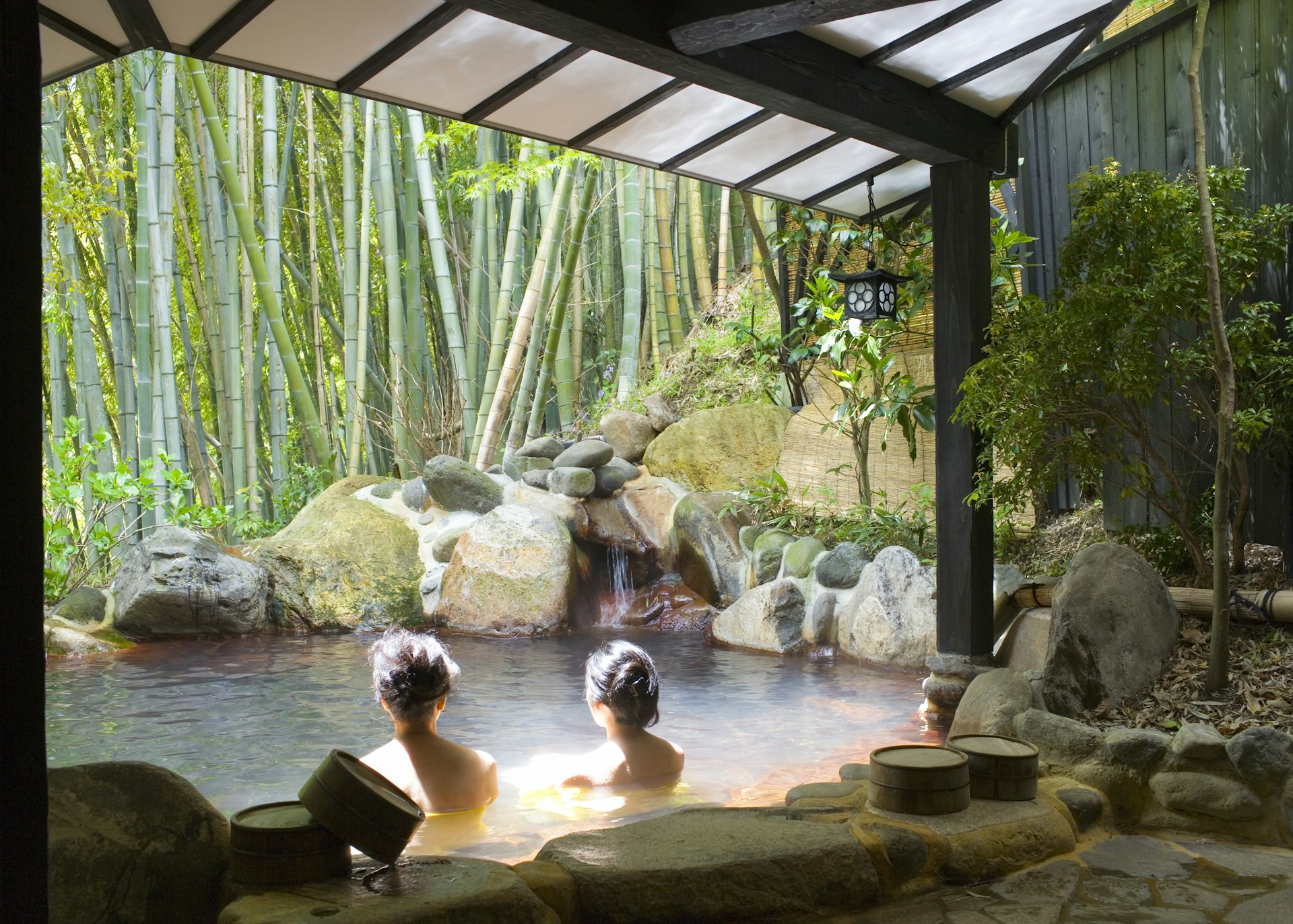 Women bathing in an outdoor pool (rotemburo) at Yumotoso - a hot spring resort in Kurokawa Onsen.