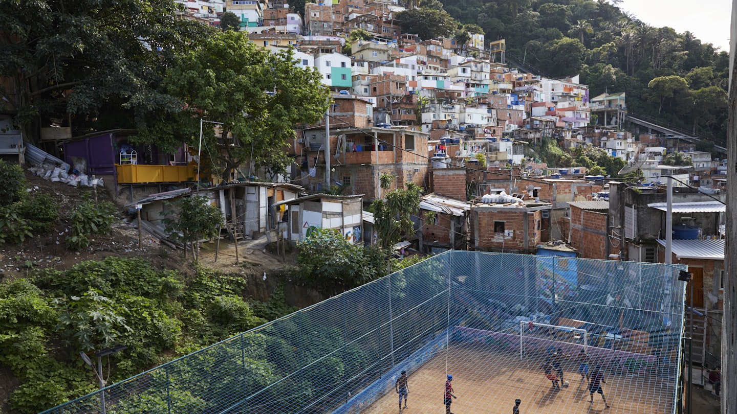 High shot of a dirt football court with a Rio favela in the background. A group of men are playing football.
855872650
View of a football court in a favela in Rio de Janeiro - stock photo
High shot of a dirt football court with a Rio favela in the background. A group of men are playing football.