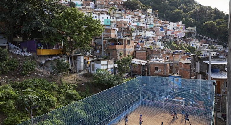 High shot of a dirt football court with a Rio favela in the background. A group of men are playing football.
855872650
View of a football court in a favela in Rio de Janeiro - stock photo
High shot of a dirt football court with a Rio favela in the background. A group of men are playing football.