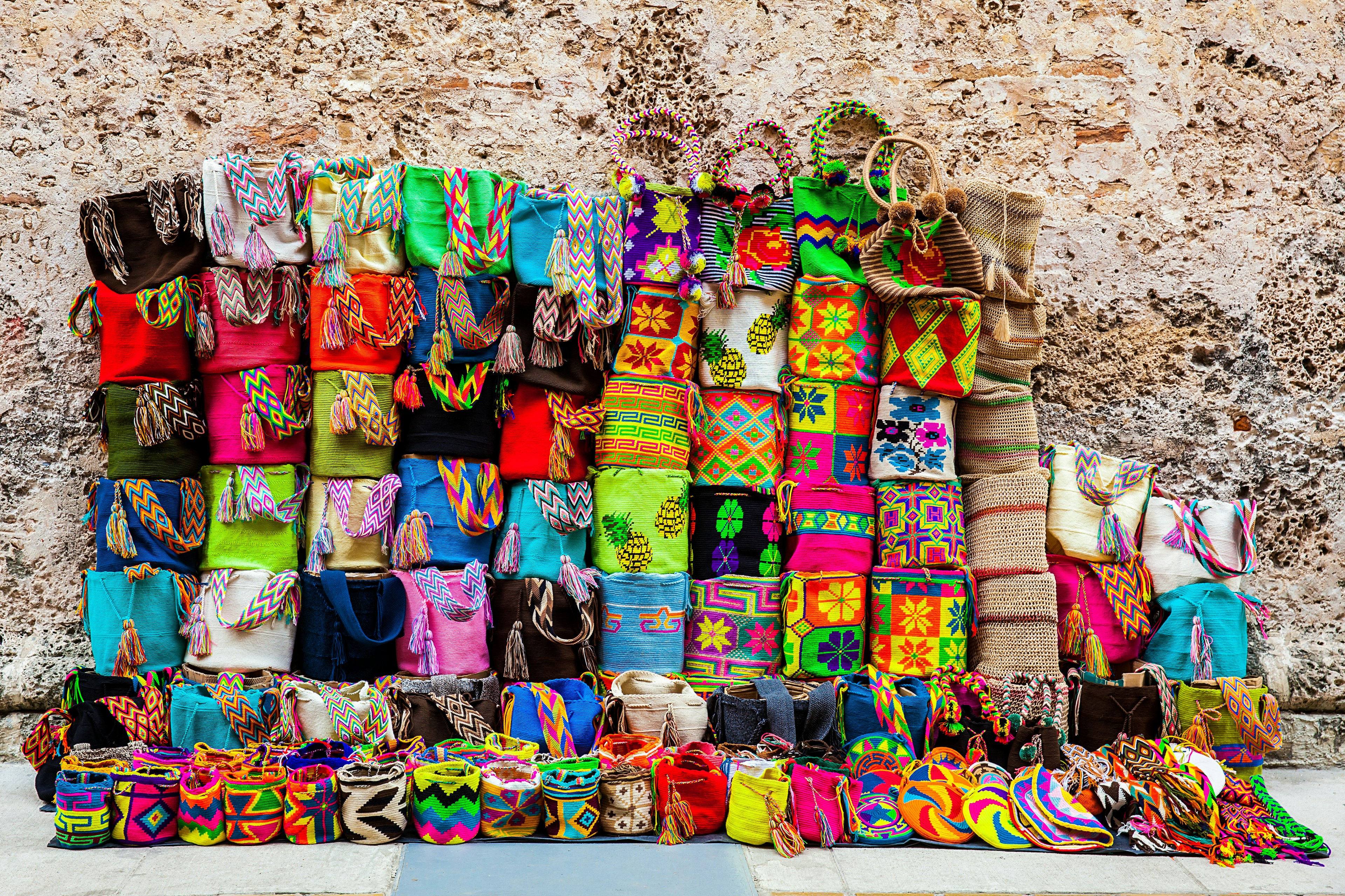 Colourful handcrafted Wayuu bags on display.