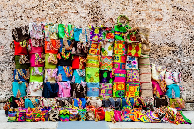 Colourful handcrafted Wayuu bags on display.