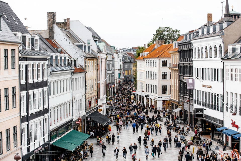 High-angle view of a busy shopping street in Copenhagen.
Rooftop, Photography, Denmark, Road, Population Explosion, Scandinavian Culture, Overcast, City, Window, Cafe, Tourist, Consumerism, Restaurant, Copenhagen, Facade, City Life, Danish Culture, Aerial View, Urban Skyline, Day, Diminishing Perspective, Amagertorv, Crowd, Retail, City Street, Capital Cities, Town Square, Sky, Street, Famous Place, International Landmark, Large Group Of People, Tourism, Retail Place, Shopping, Travel, Cityscape, Architecture, Old, Oresund Region, Building Exterior, People, Color Image, Sidewalk Cafe, Outdoors, High Angle View, Travel Destinations, Horizontal, Pedestrian Zone