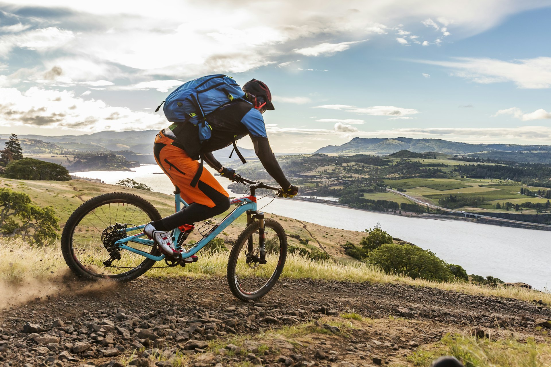 Mountain biker riding on a trail along the Columbia River in Hood River, Oregon.