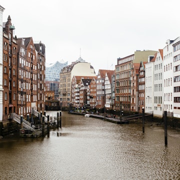 854408680
Architecture; Brick; Bridge - Built Structure; Building Exterior; Built Structure; Business Finance and Industry; Canal; City; City Life; Cityscape; Color Image; Day; Economy; Elbphilharmonie; Europe; European Culture; Facade; Finance and Economy; German Culture; Germany; Hamburg; Hamburg - Germany; Harbor; History; Horizontal; In A Row; No People; Old Town; Outdoors; Overcast; Photography; River; Travel; Travel Destinations; Urban Skyline; Water; Waterfront; Western Europe;
Hamburg historic district with old buildings along the canal, Germany.