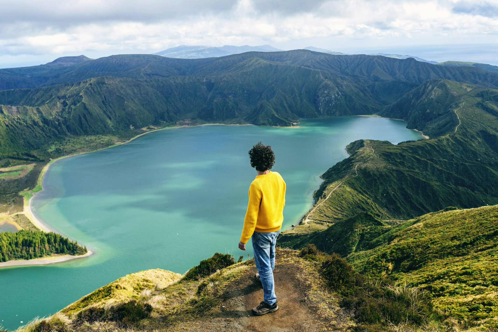 A hiker looking down on Lagoa do Fogo, São Miguel, Azores, Portugal