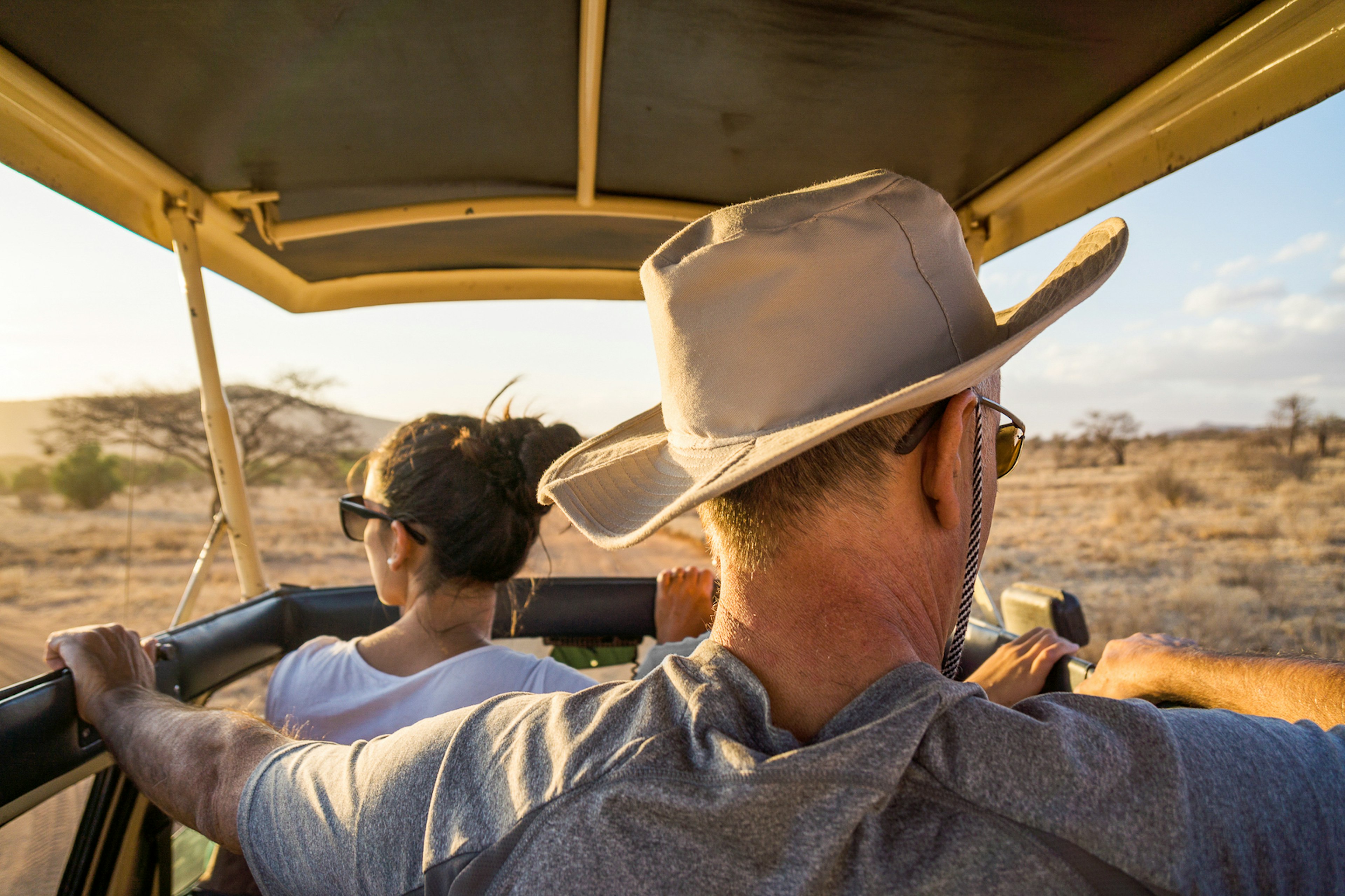 Two people looking out of a Jeep Safari in Kenya, Africa