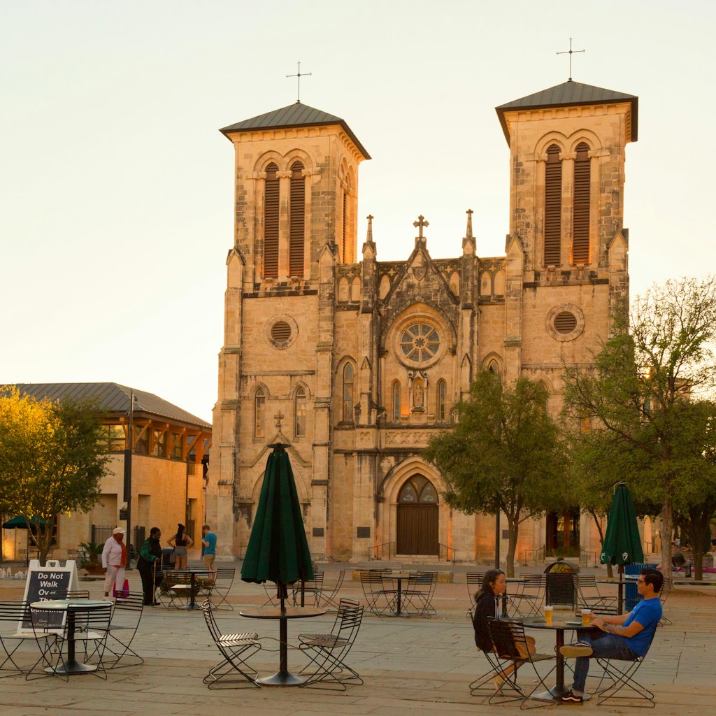 A couple having an evening drink in front of San Fernando Cathedral, San Antonio, Texas USA