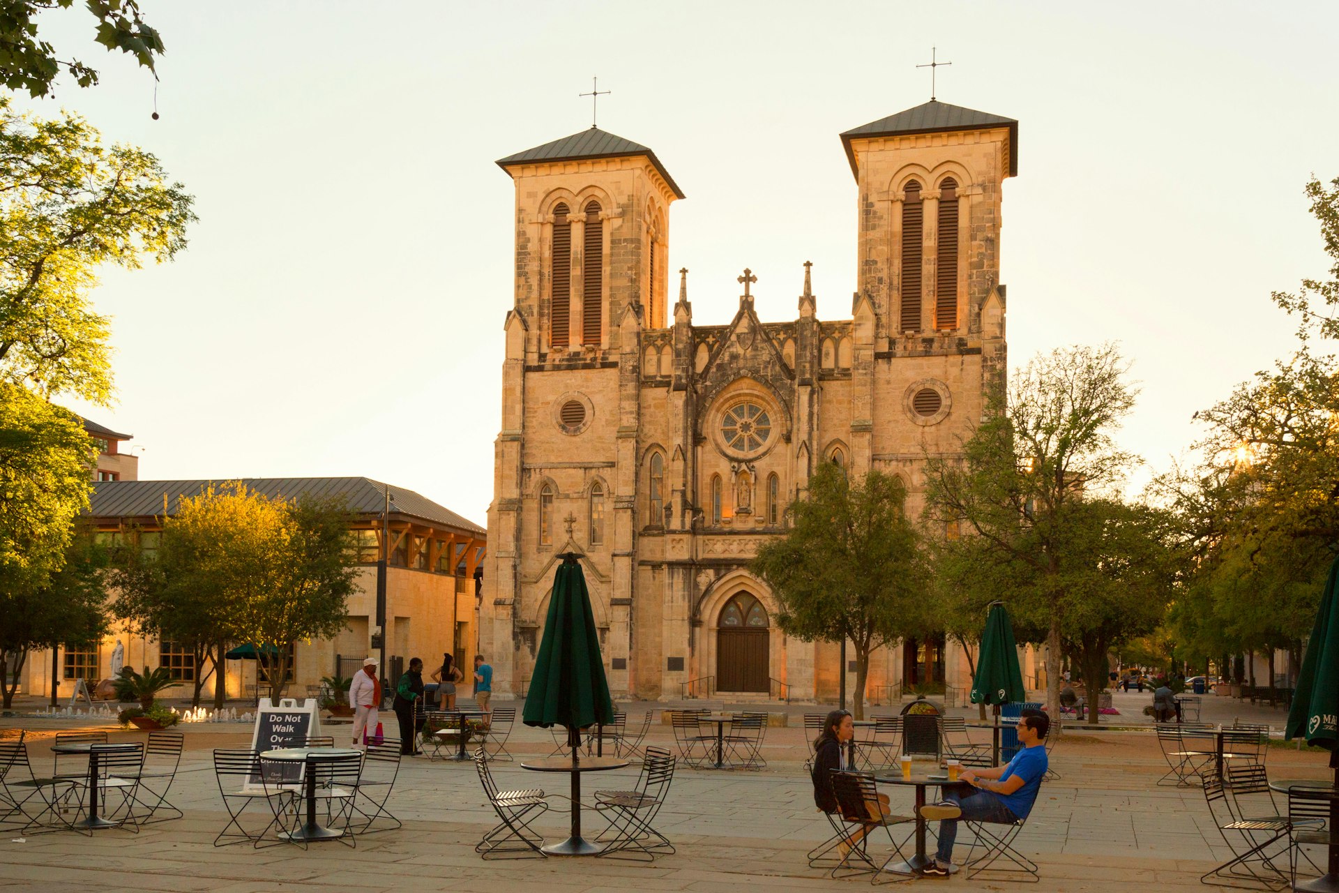 A couple sat having an evening drink in front of San Fernando Cathedral, San Antonio, Texas 
