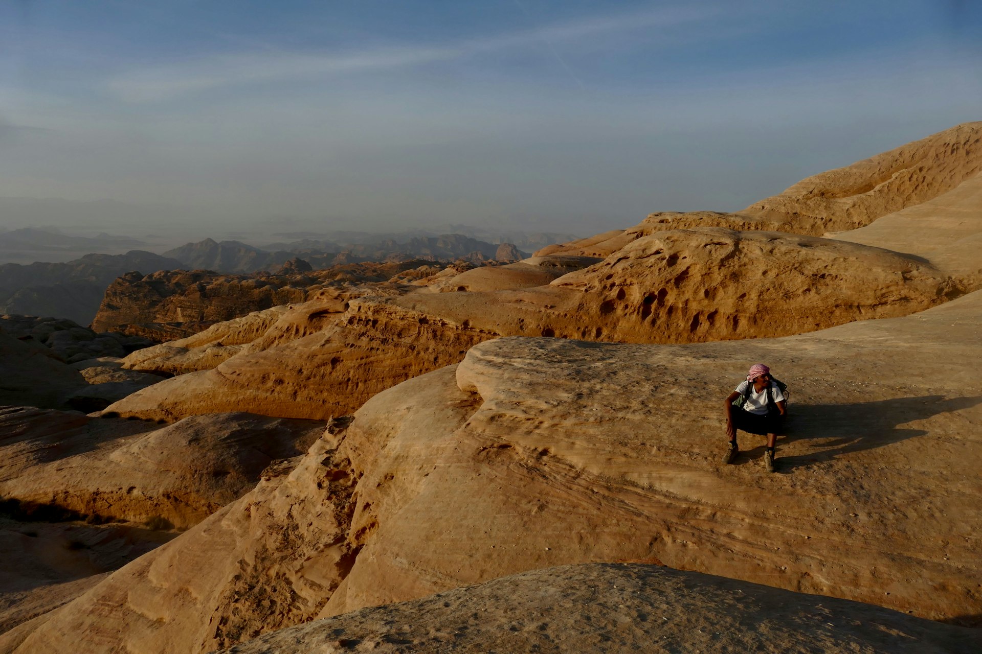 A Bedouin climbing guide rests on the high sandstone uplands of Jebel Rum, Wadi Rum, Jordan
