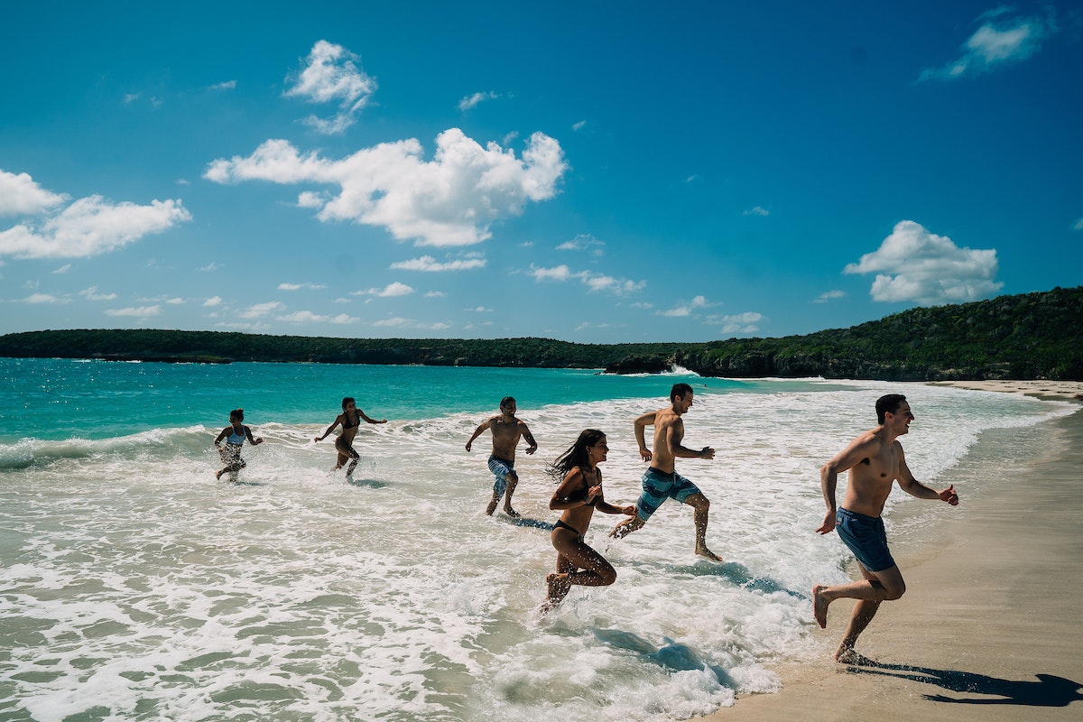 A family runs out of the sea at the wild Caracas Beach in Vieques, Puerto Rico