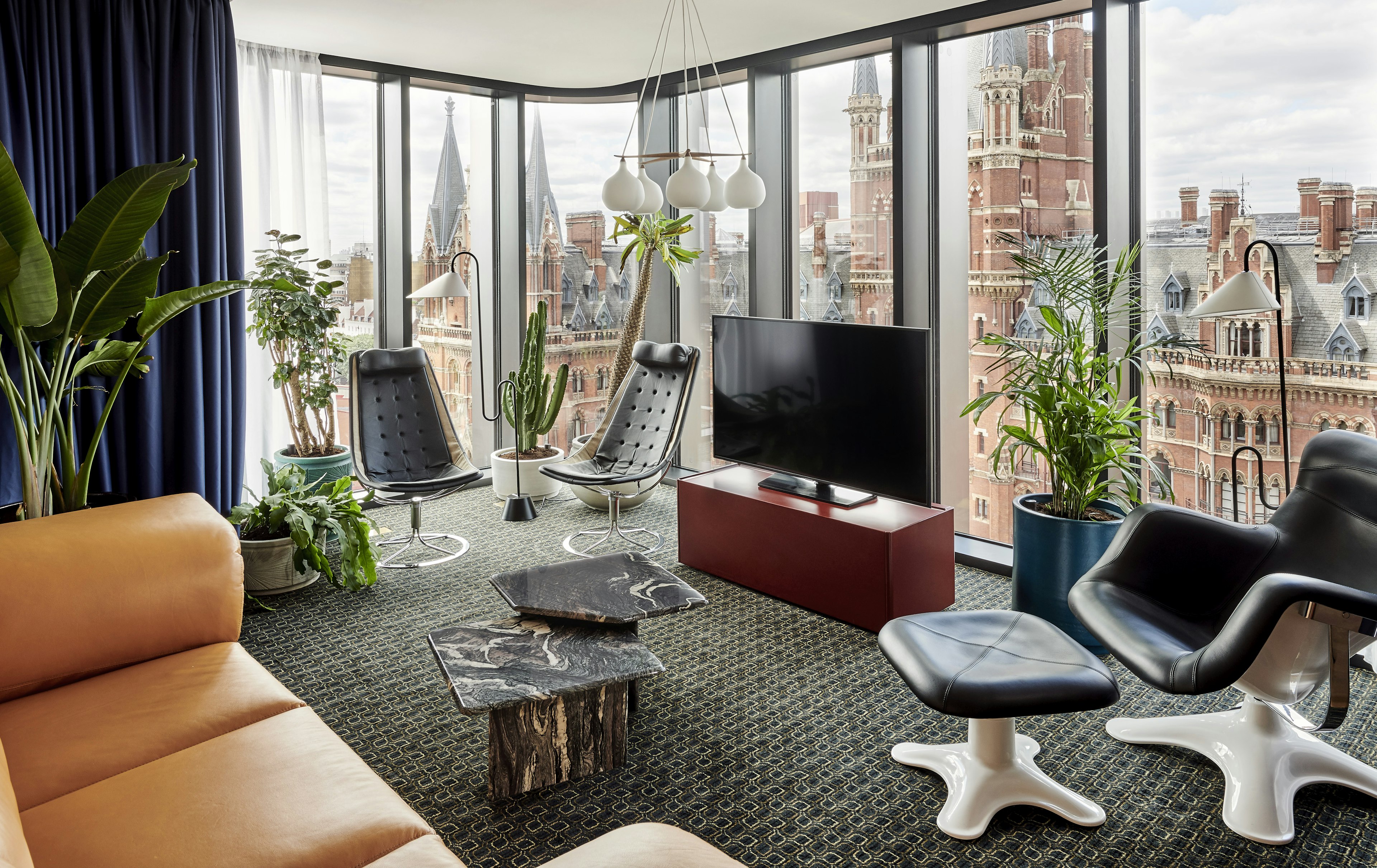 A modern hotel room with a window looking out at St Pancras Station in London.