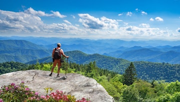 Man standing on top of the mountain relaxing and  enjoying beautiful summer mountain landscape. A panoramic view of the Smoky Mountains from the Blue Ridge Parkway in North Carolina. Near Asheville.; Shutterstock ID 1907256715; your: Sloane Tucker; gl: 65050; netsuite: Online Editorial; full: destination
1907256715
