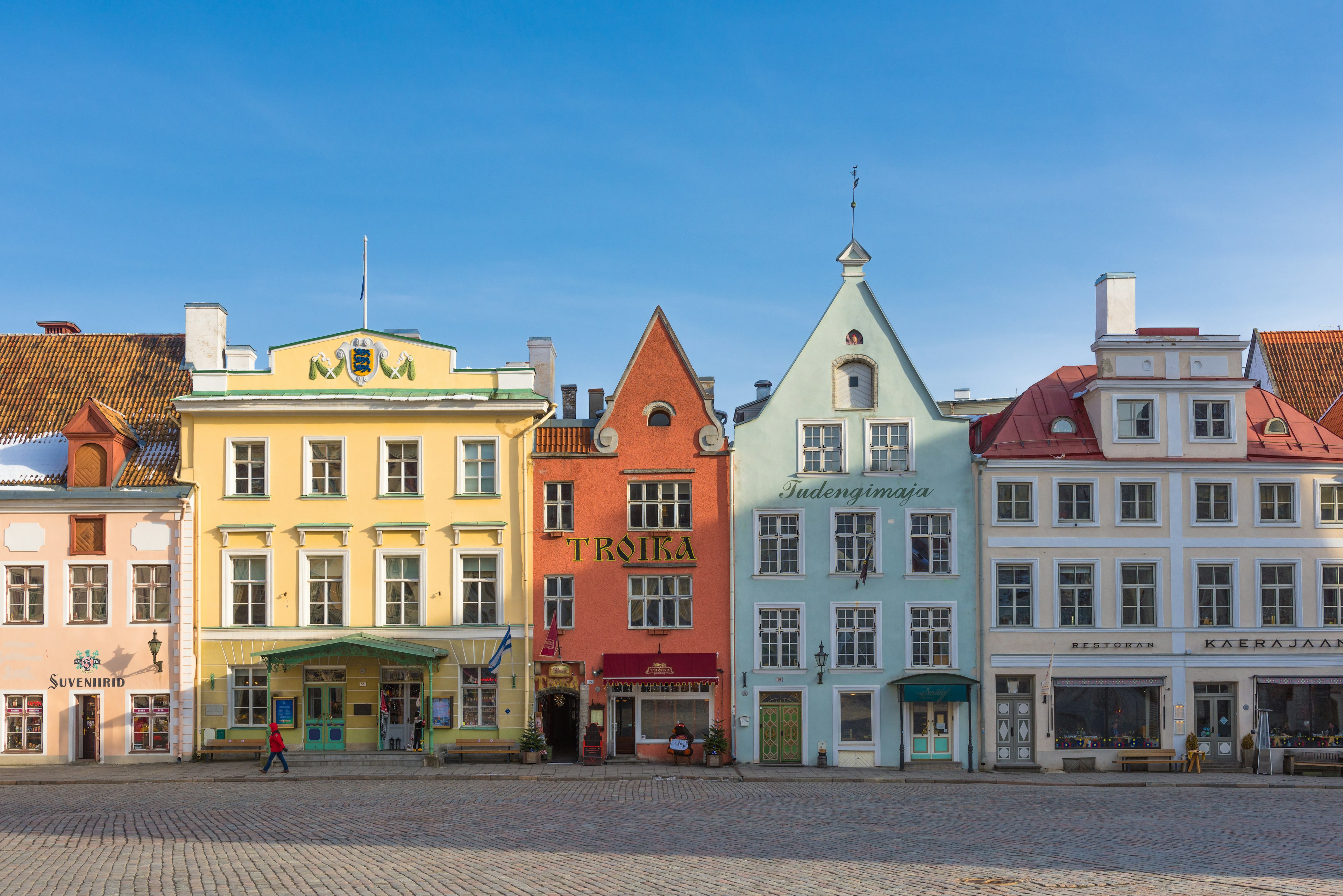 Historic buildings line a public square in Tallinn's Old Town.