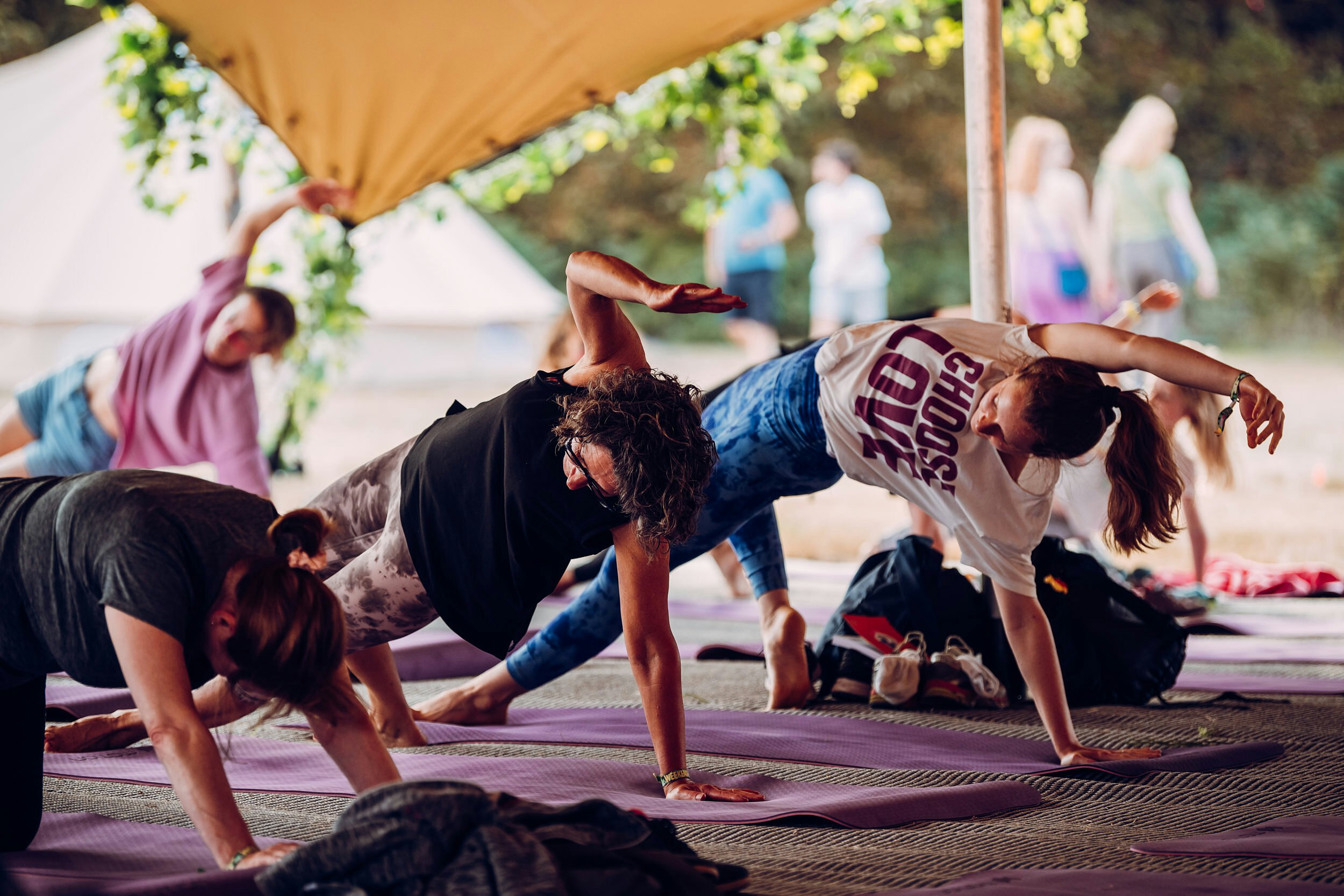 People doing yoga in a bell tent at Latitude music festival UK