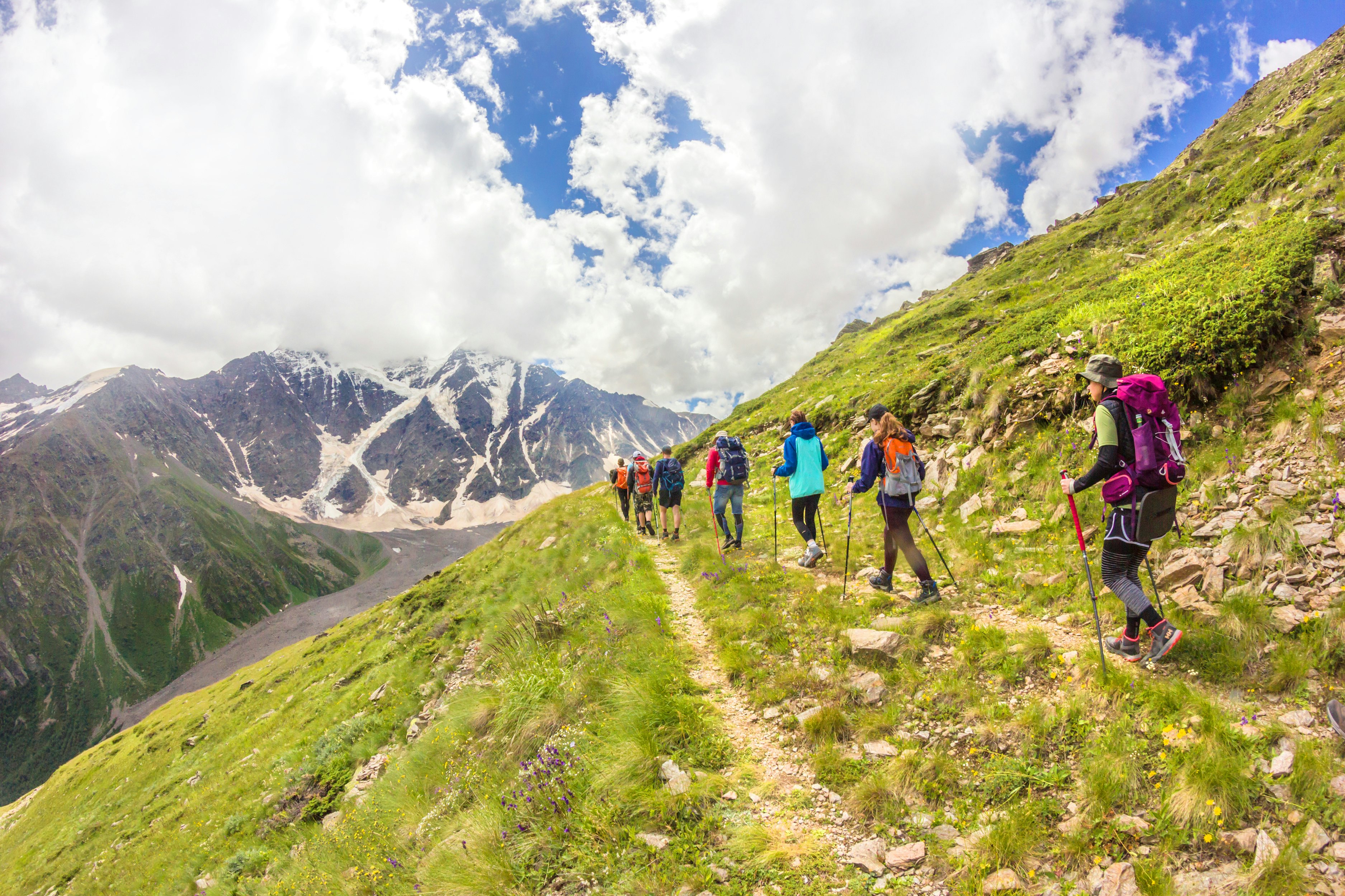 A group of climbers follow each other in a chain while climbing Mt Elbrus, Russia.