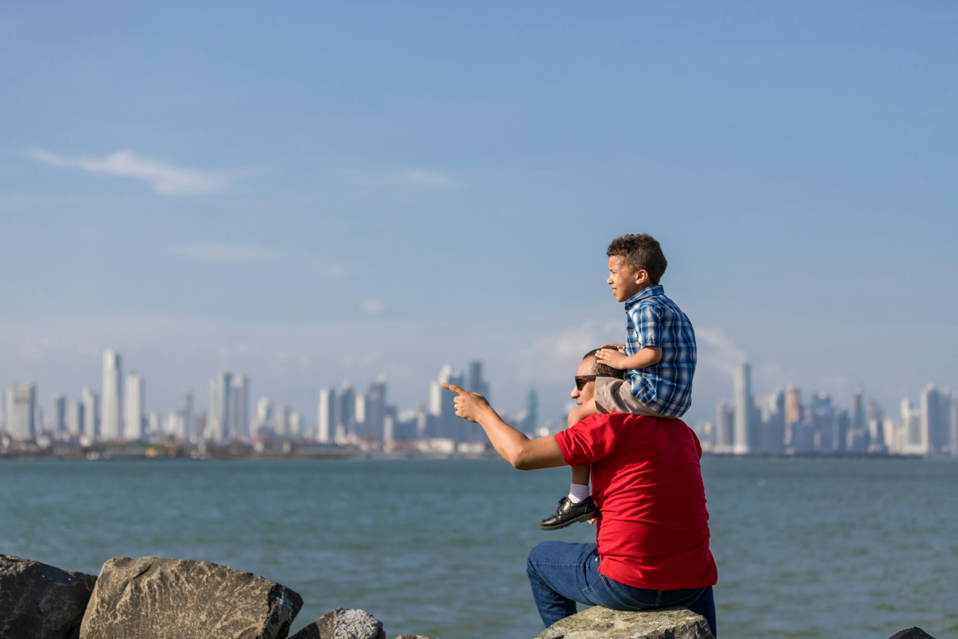Father and son looking at the city of Panama