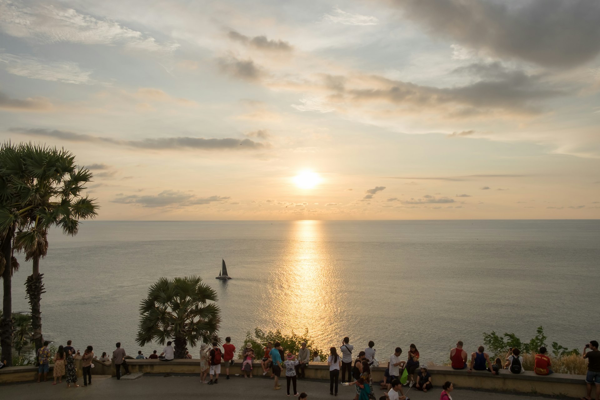 Tourists gather to watch the sunset on the Arabian Sea, Laem Phromthep, Phuket, Thailand