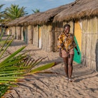 African woman outside Bungalow house with thatched roof and built in old tradition way on a beach in Ada Foah located at volta region Ghana West Africa; Shutterstock ID 1543016051; your: Claire N; gl: 65050; netsuite: Online ed; full: Ghana places to go
1543016051