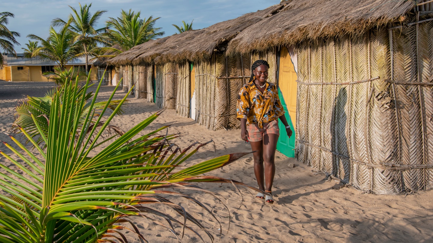 African woman outside Bungalow house with thatched roof and built in old tradition way on a beach in Ada Foah located at volta region Ghana West Africa; Shutterstock ID 1543016051; your: Claire N; gl: 65050; netsuite: Online ed; full: Ghana places to go
1543016051