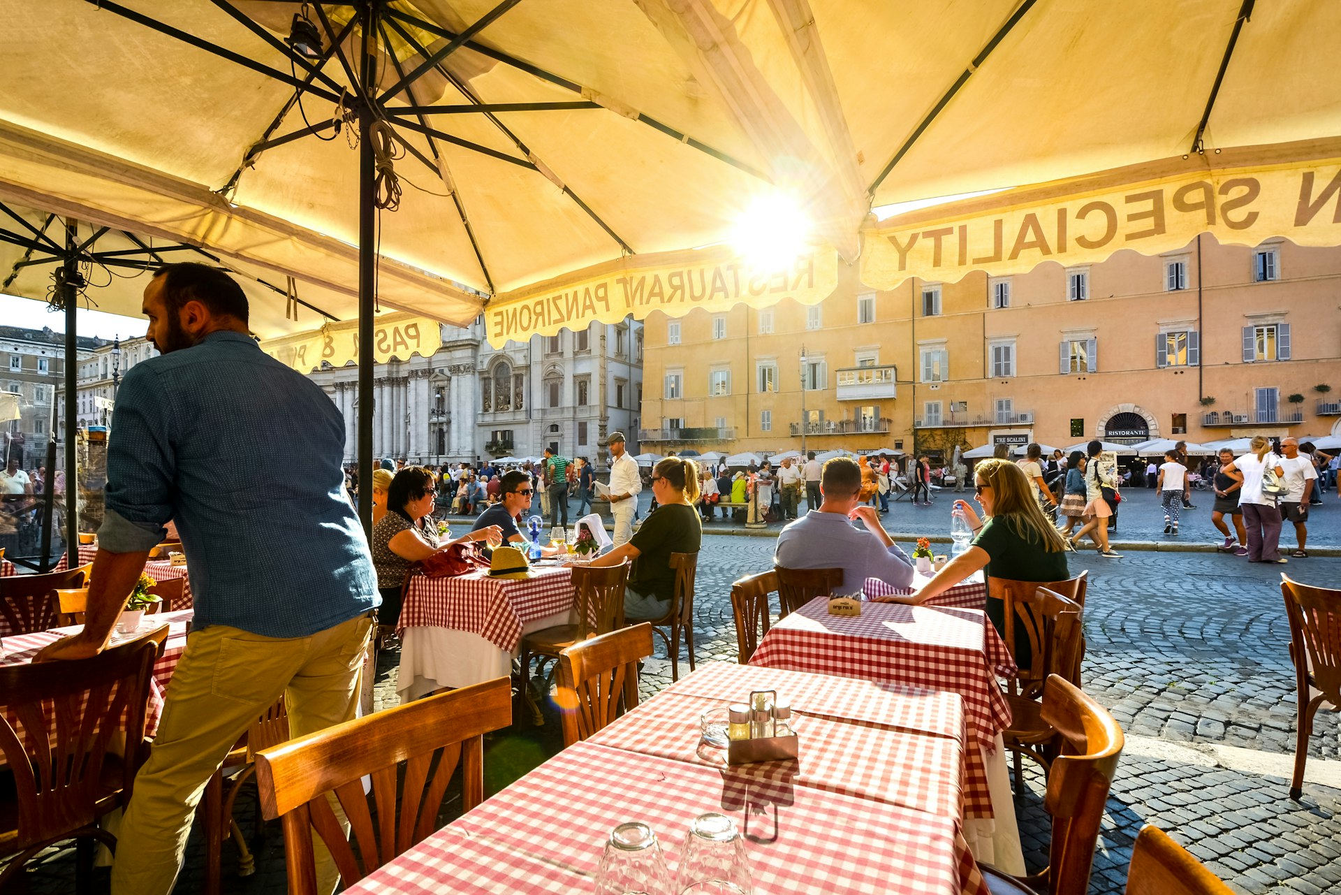 Tourists dine at a romantic Italian restaurant, Piazza Navona, Rome, Italy