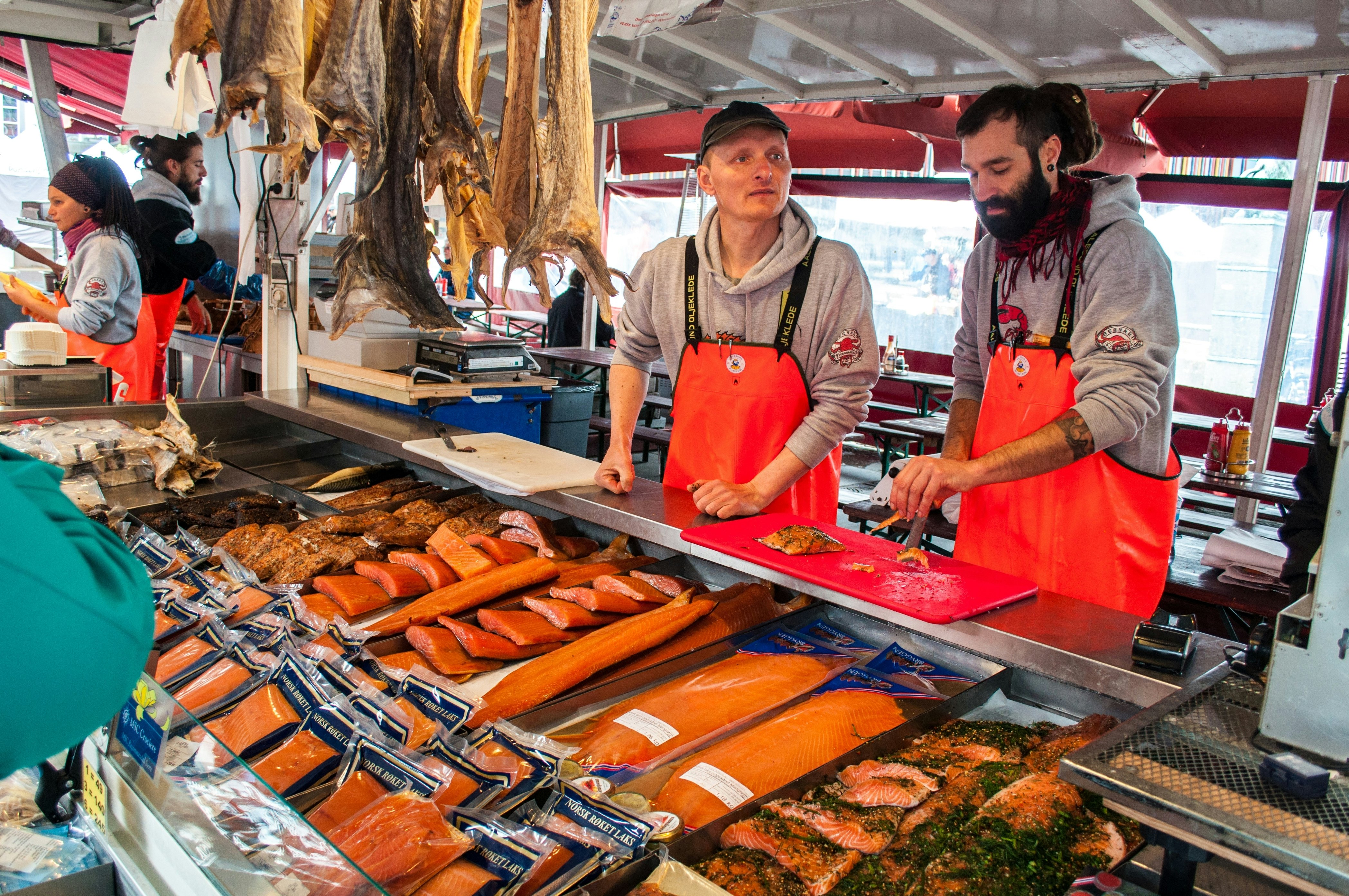 Two sellers of fresh fish at the fish market, Bergen, Norway