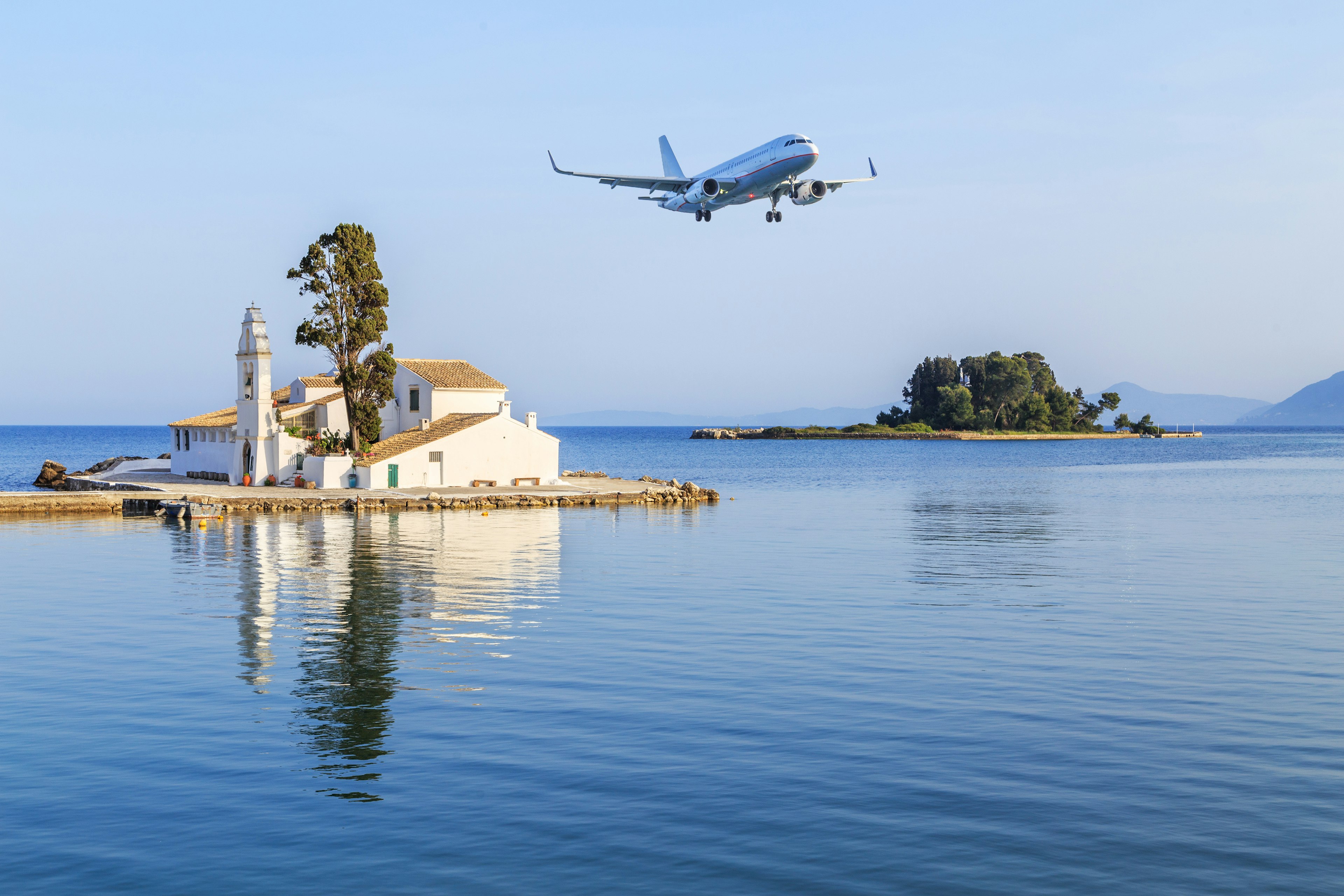 Plane landing over the Vlacherna Monastery in Kerkyra in Corfu, Greece