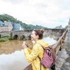 Young woman in yellow raincoat traveling with backpack and photo camera in Dinan village at Brittany region in France; Shutterstock ID 667908934; your: Tasmin Waby; gl: 65050; netsuite: Online Editorial; full: Brittany TTD
667908934