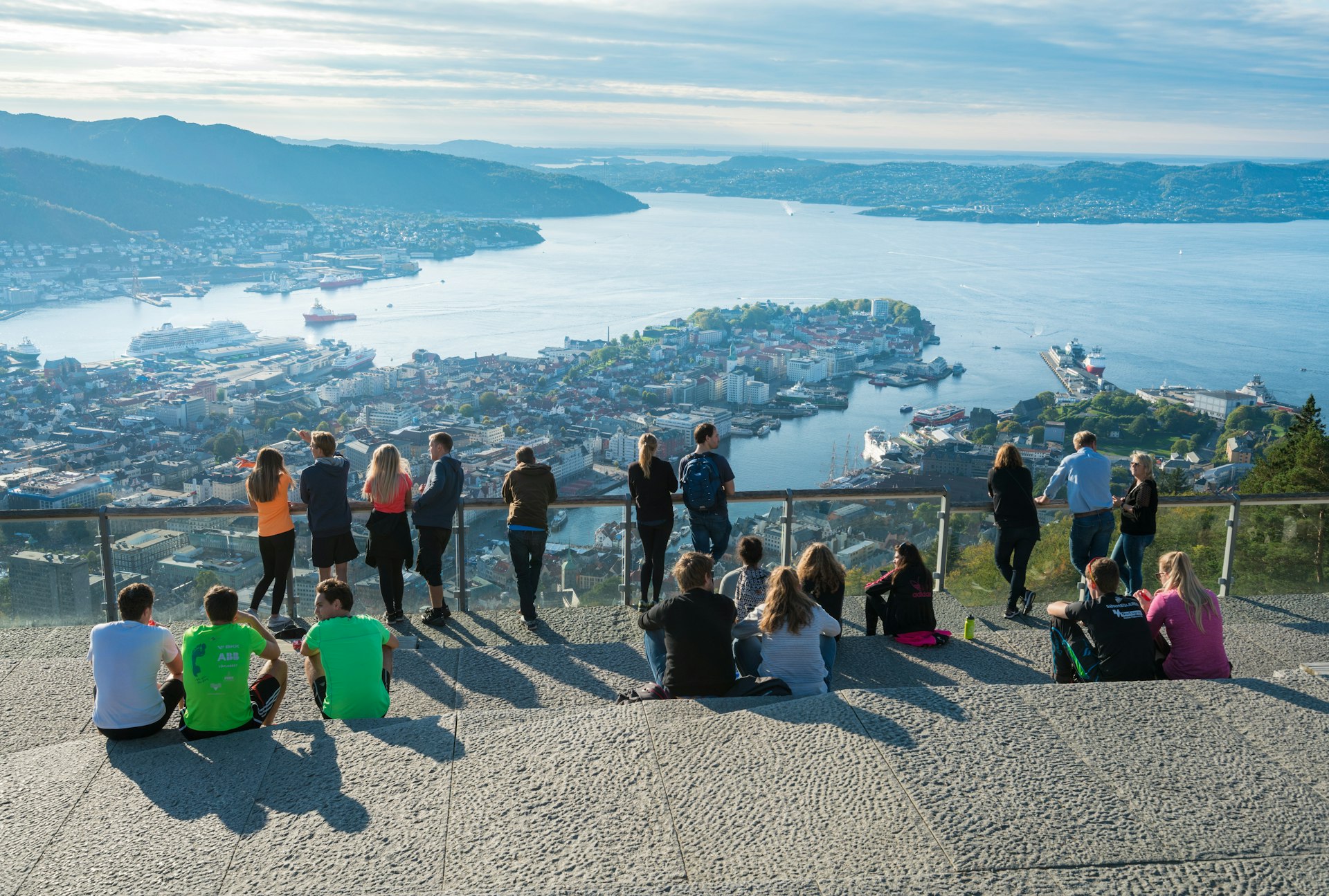 Tourists admire the view from Mt Fløyen over the city of Bergen, Norway