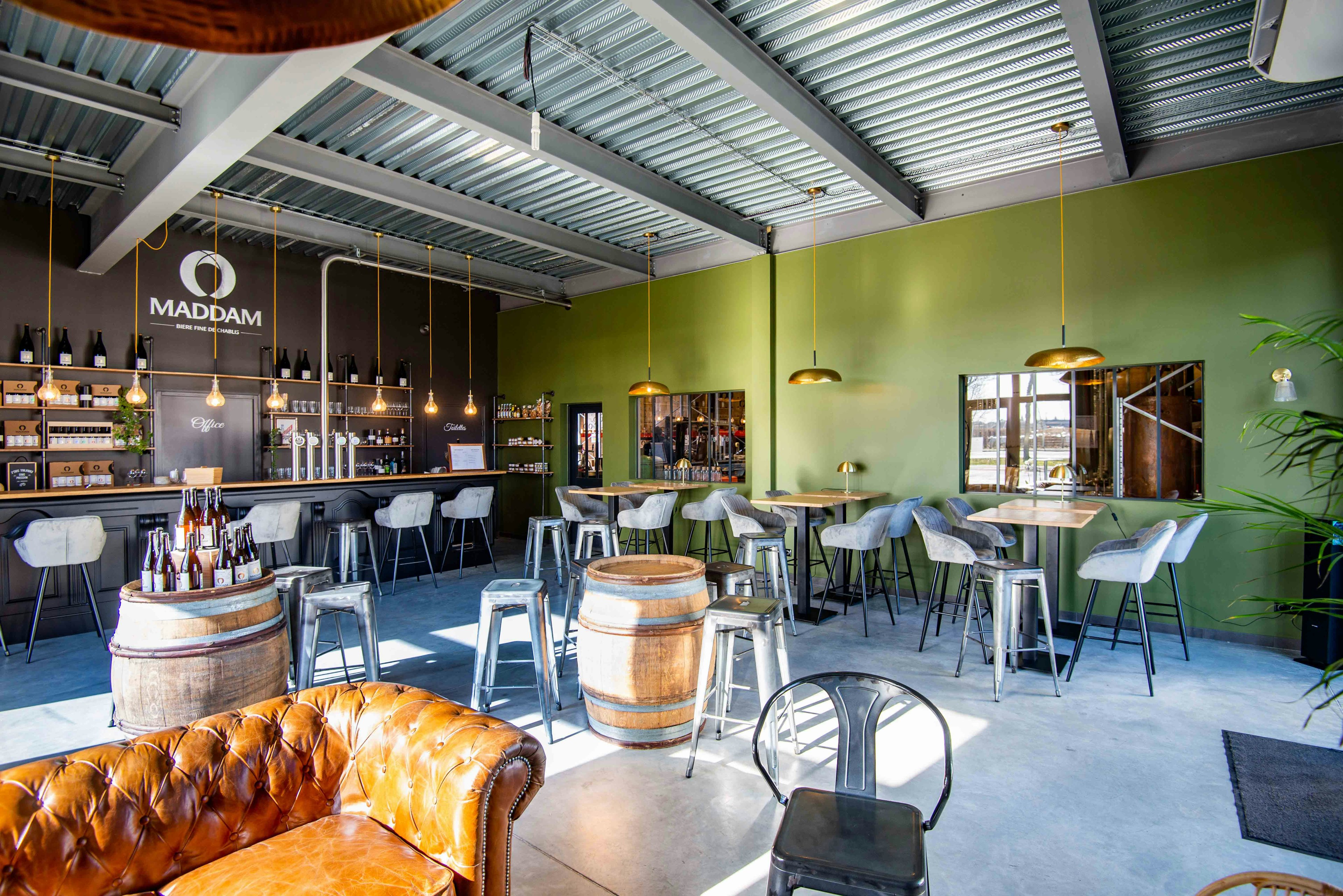 The interior of a sleek and modern microbrewery with seating for visitors.