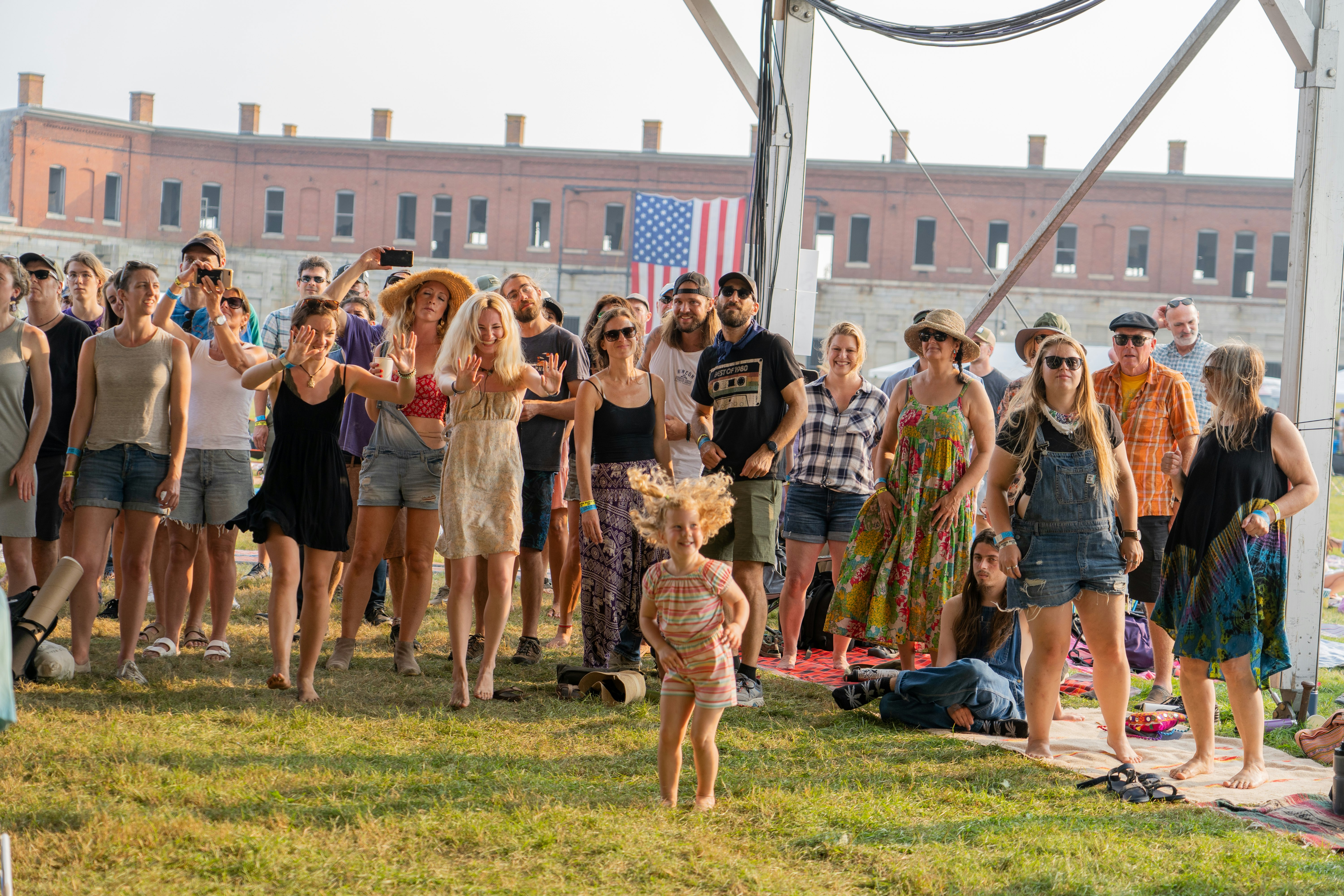 A young girl dances in front of a crowd at the Newport Folk Festival. 