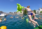 F0X52H Zurich, Switzerland. 22nd August, 2015. Swimmers are jumping into Zurich's cool Limmat river to drift down 2km through the city. Sunny weather and warm temperatures at Zurich's traditional "Limmatschwimmen" ("swim down the Limmat river") attracted 4500 swimmers who, equipped with rubber turtles and other fancy floating devices, enjoyed drifting down the river through Zurich. Credit:  Erik Tham/Alamy Live News
F0X52H Zurich, Switzerland. 22nd August, 2015. Swimmers are jumping into Zurich's cool Limmat river to drift down 2km through the city. Sunny weather and warm temperatures at Zurich's traditional Limmatschwimmen (swim down the Limmat river) attracted 4500 swimmers who, equipped with rubber turtles and other fancy floating devices, enjoyed drifting down the river through Zurich. Credit:  Erik Tham/Alamy Live News
F0X52H
water, fun, event, Limmat, river, swim, refreshment, jump, Zurich, event, river, Limmat, city, swimming, swimmer, swim, water, gathering, fun, sports, water, many, people, enjoy, drift, jump, floating, device, Limmatschwimmen, happiness, outdoors, splash, jumping, cool, action, afloat, bath, bathing, summer, hot, refreshment, refreshing, recreation, Crowded, Europe, Limmat, Limmatschwimmen, Switzerland, Zurich, busy, crowd, drift, enjoy, event, float, floating, device, fun, fun, event, funny, gathering, happy, jump, many, many, people, mass, gathering, odd, outdoors, people, river, rubber, duck, slow, splash, sports, swim, swimmer, swimming, traditional, water, water, sports
Swimmers are jumping into Zurich's cool Limmat river to drift down 2km through the city.